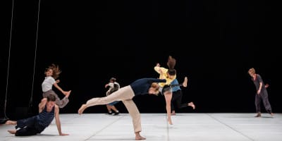 Performances & Events at Candoco. Six overlapping dancers are on an empty stage.